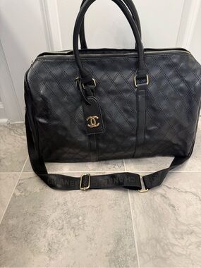 CHANEL Black Quilted Lambskin Duffel Bag with Gold CC Charm